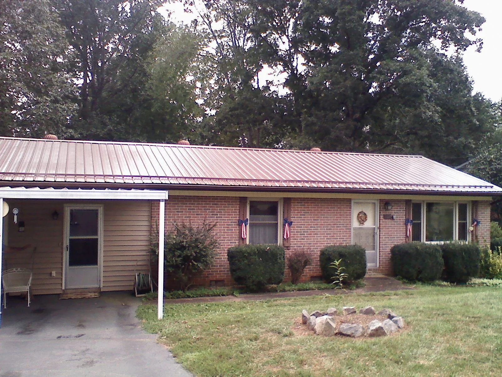 Bronze metal roof and carport on a brick ranch home — Roof Repair work by our crew in Hemet