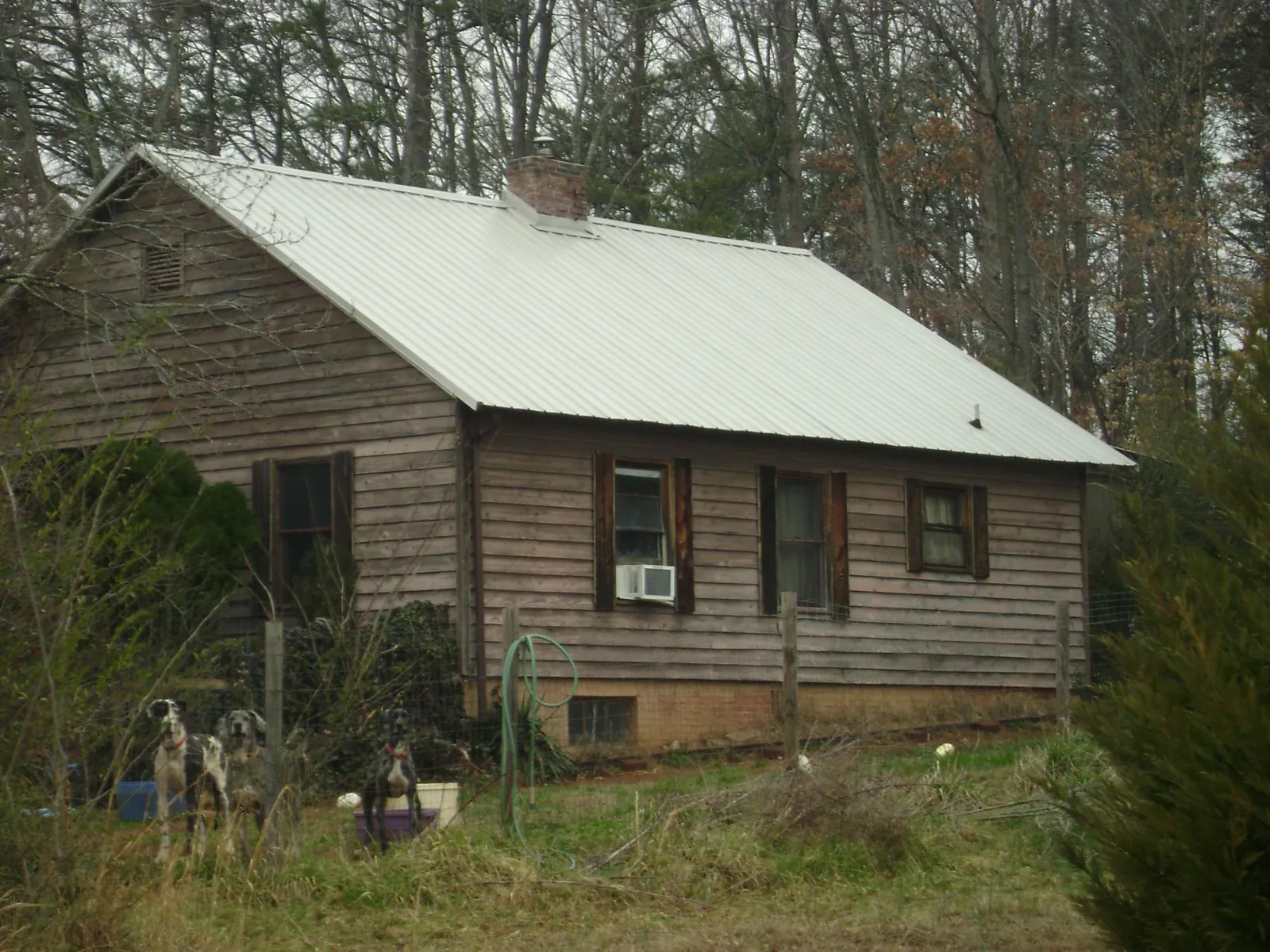 White metal roof on an old wood sided farmhouse, from a Asphalt Shingle Roof Repair job in Hemet